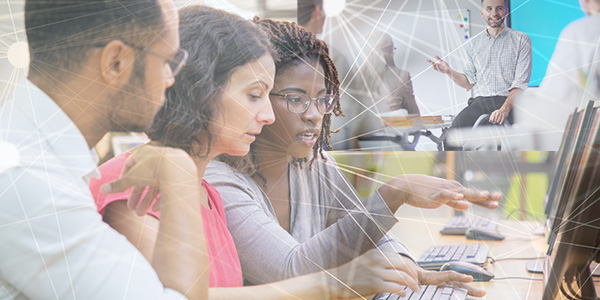 Three people looking at a computers creen with illustrated conneted lines throughout